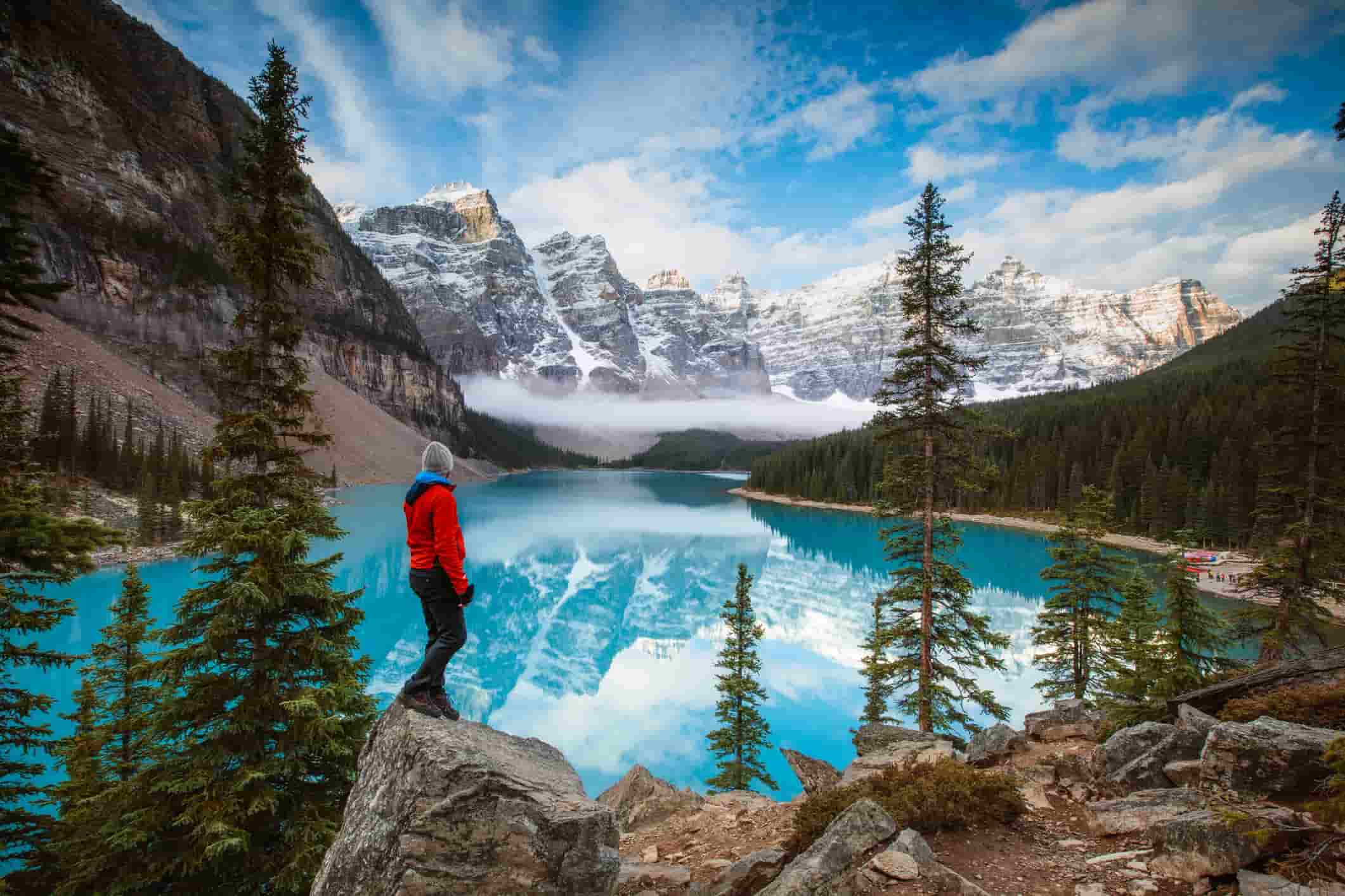 a man looking at Moraine Lake in Banff National Park. Alberta, Canada