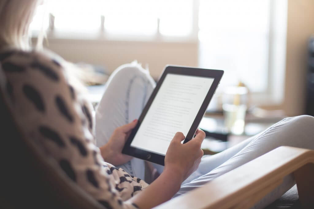 a woman holding an iPad