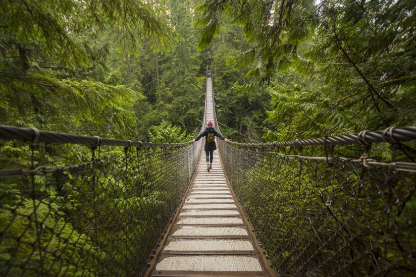 Woman on Lynn canyon suspension bridge, North Vancouver, British Columbia, Canada