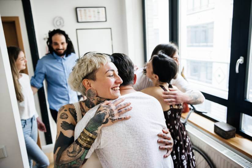 a group of friends hugging each other