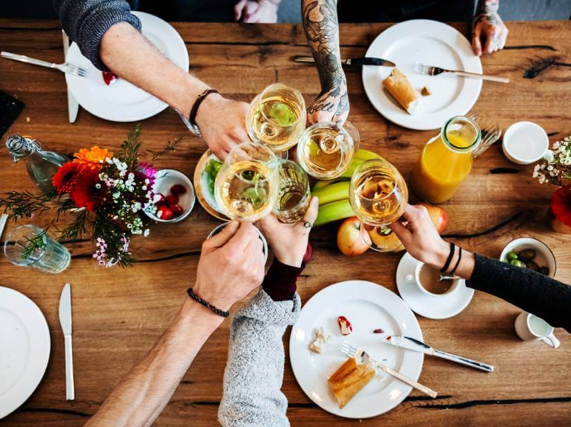 people having dinner and having a toast