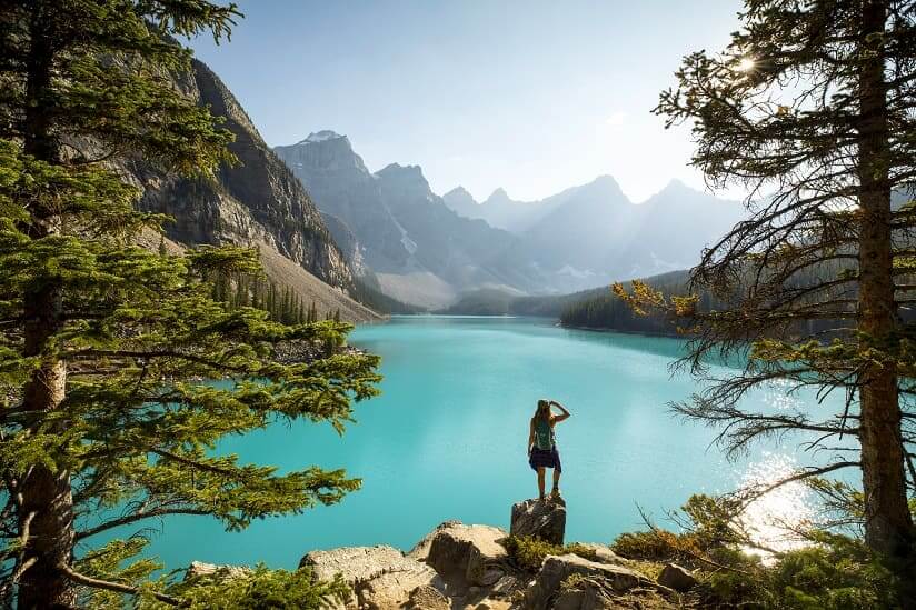 a woman looking at a Canadian lake