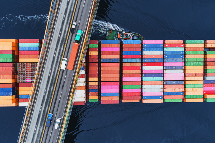 a large ship passing under a bridge