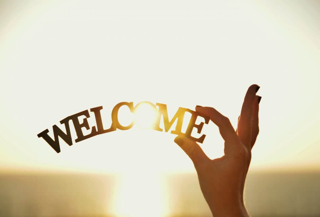 woman holding a welcome sign